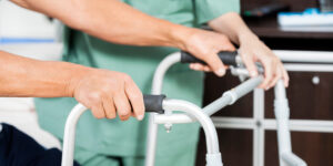 man holding a walker finding out how to deal with short or long term disability