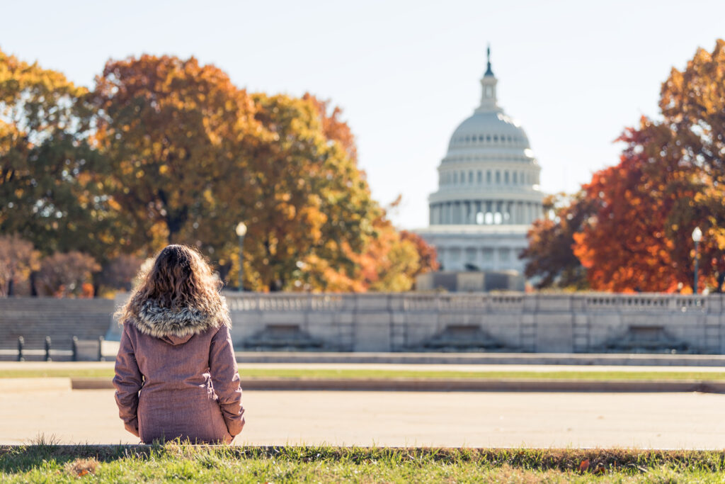 woman sitting in front of the Capitol building learning about the different types of government backed loans