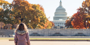 woman sitting in front of the Capitol building learning about the different types of government backed loans