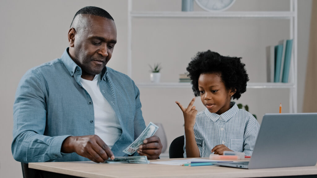 father and daughter showing how to teach financial concepts to your kids