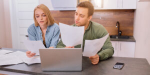 young couple reviewing paperwork to get ready to apply for a home loan