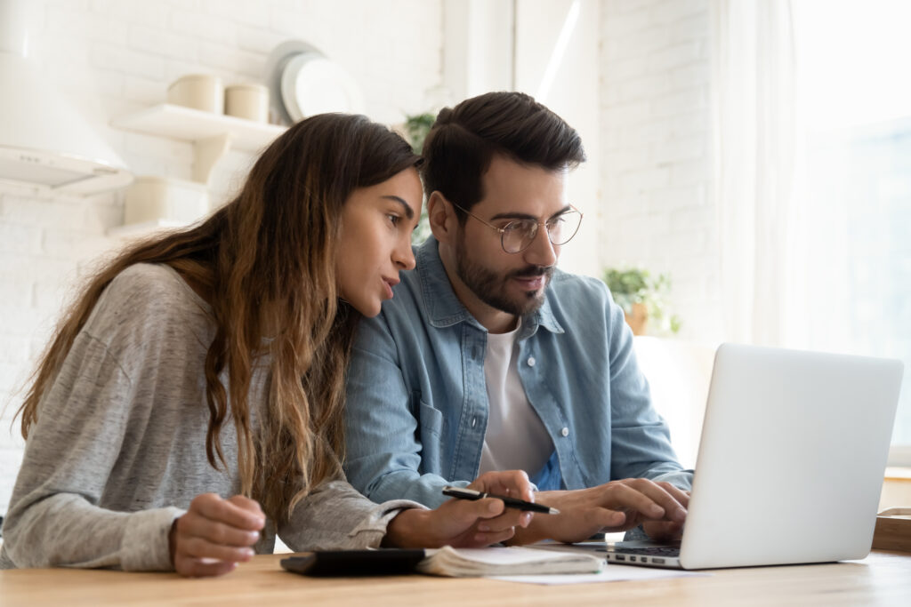 young couple looking for an online loan from their bank