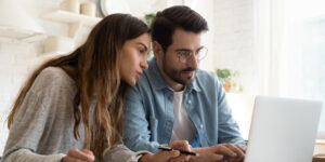 young couple looking for an online loan from their bank