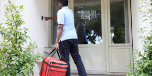 young man delivering food to a house