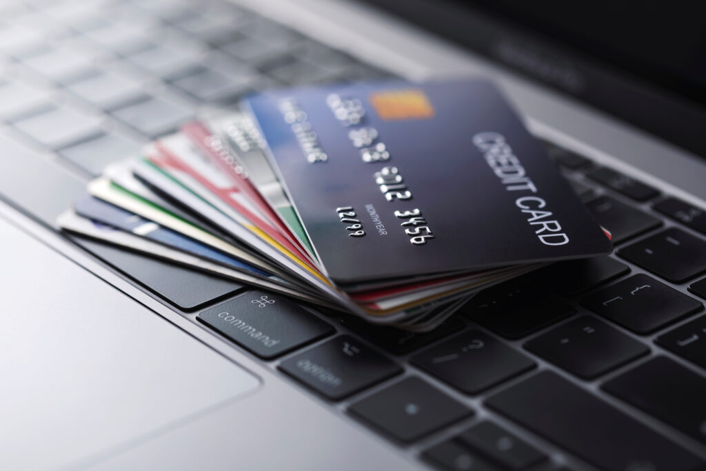 different types of credit cards spread across computer keyboard