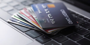 different types of credit cards spread across computer keyboard