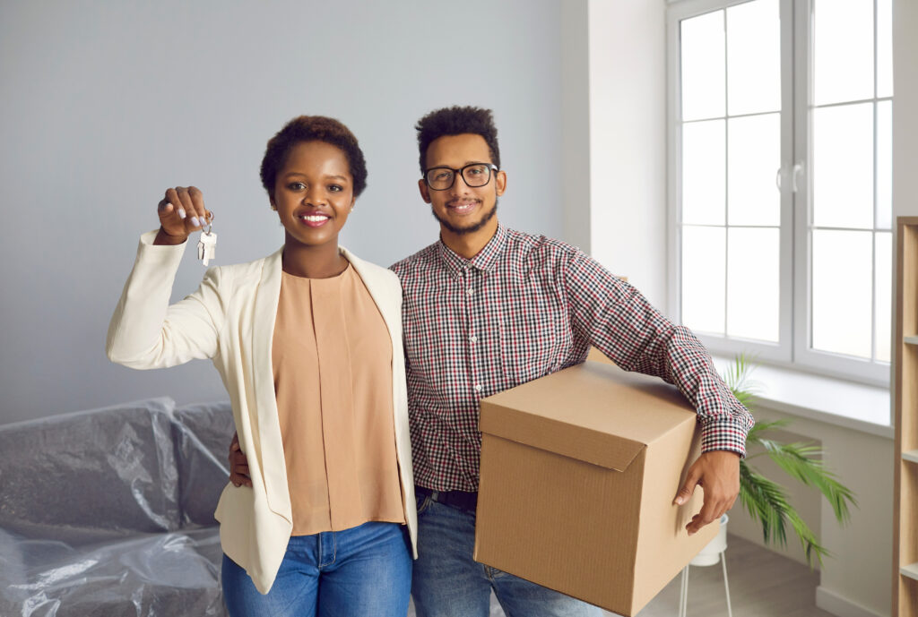 first time home buyers holding keys and boxes